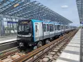 Un train de la ligne 11 du Grand Paris, direction Rosny-Bois-Perrier, s'arrête à la station Coteaux-Beauclair sous une structure moderne.