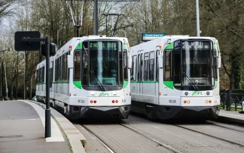 Deux trams blancs et verts de la Tan à Nantes, prêts à offrir un transport nantes gratuit. Ligne 2 vers Hôtel Dieu et Orvault Grand Val.