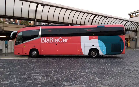 Bus BlaBlaCar rouge et blanc, prêt à partir en voyage.