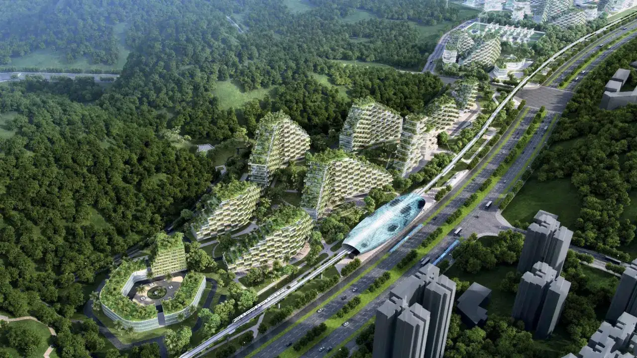 Vue a&eacute;rienne d'une ville verte, incarnant la d&eacute;finition d'une ville durable avec des b&acirc;timents recouverts de v&eacute;g&eacute;tation, un train sur&eacute;lev&eacute; et des espaces verts.