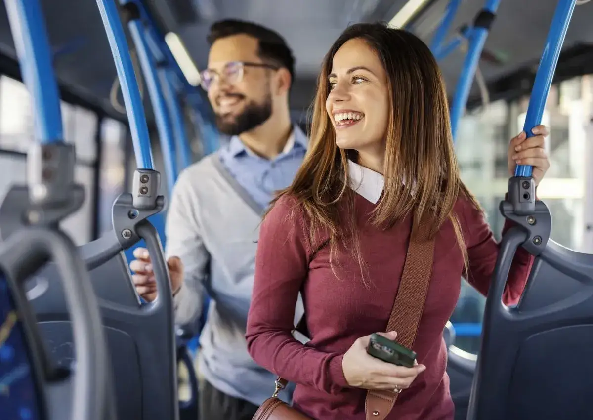 Couple souriant dans un bus Keolis Vélizy, profitant du trajet.